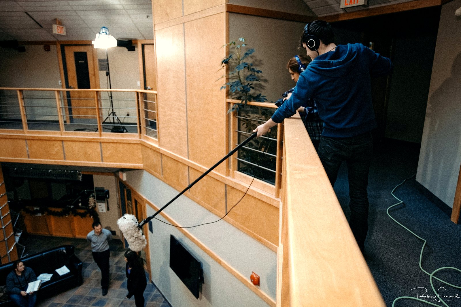 A student sound crew works a scene from the balcony