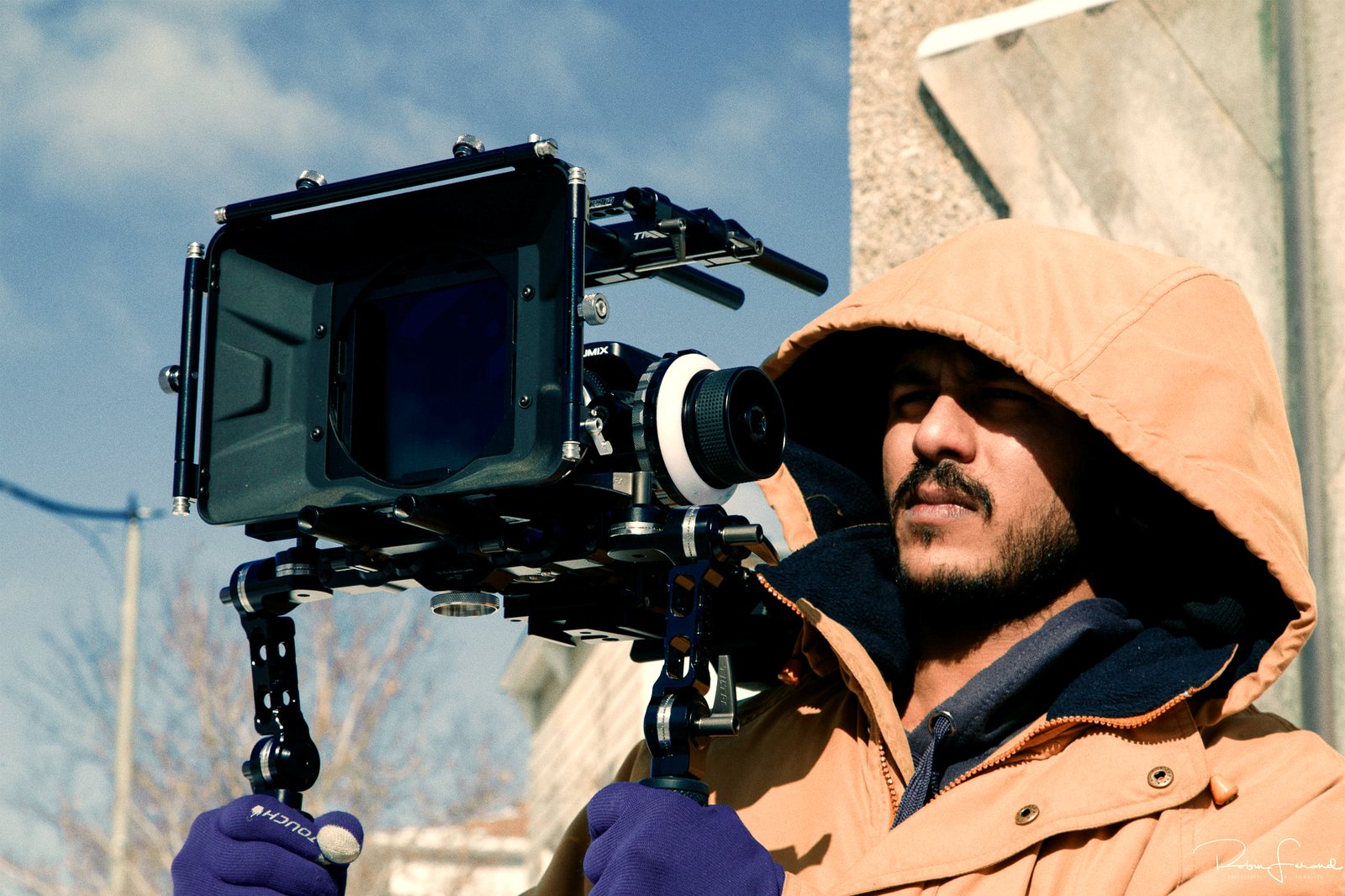 A first camera assistant preps the rig between takes